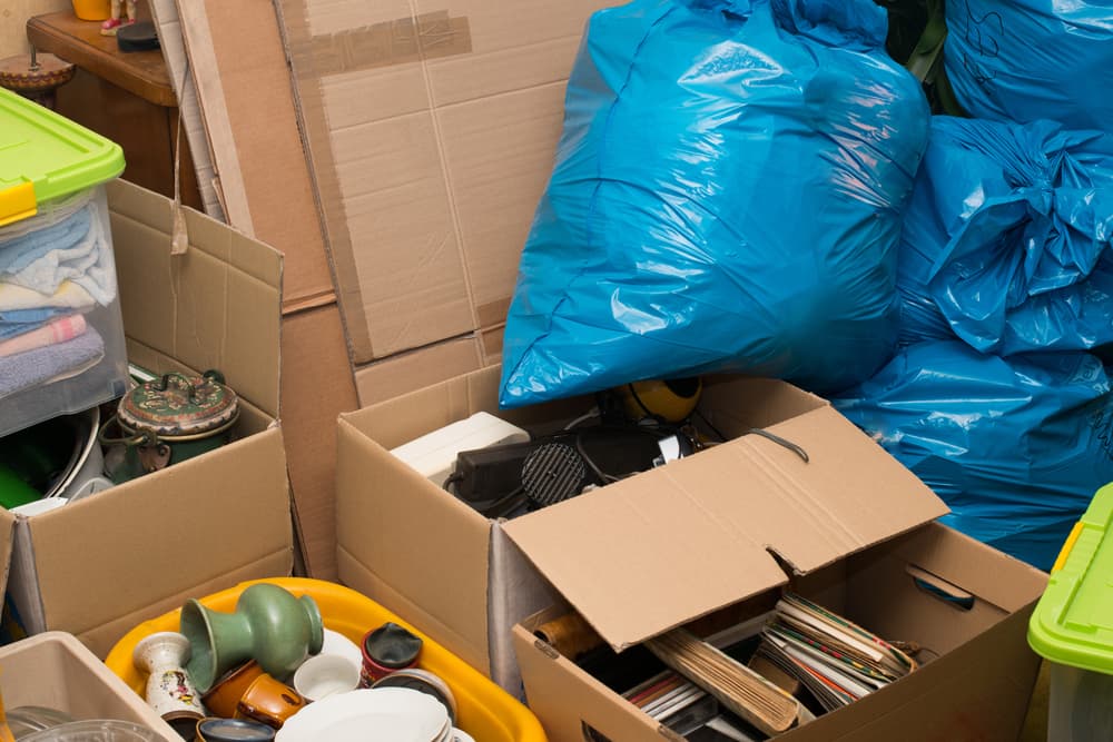 Junk removal - boxes, bags, and household items ready for hauling by Alpha Haul Pros